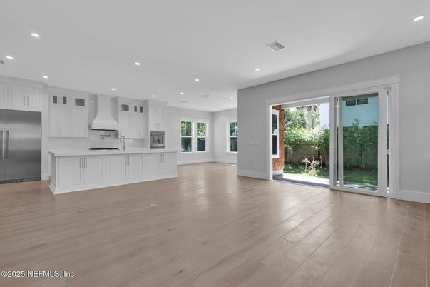 Empty room, Interior, Kitchen, Recessed Lighting, Stainless Steel Appliances, Wood Texture Flooring