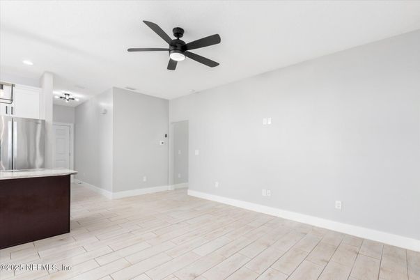 Empty room, Interior, Kitchen, Recessed Lighting, Stainless Steel Appliances, Wood Texture Flooring