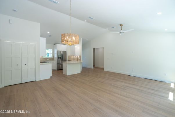 Chandelier, Empty room, Interior, Kitchen, Pendant Lights, Recessed Lighting, Stainless Steel Appliances, Wood Texture Flooring