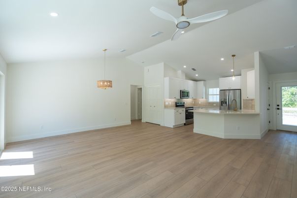 Empty room, Interior, Kitchen, Pendant Lights, Recessed Lighting, Stainless Steel Appliances, Wood Texture Flooring