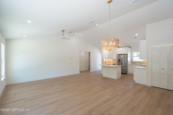Chandelier, Empty room, Interior, Kitchen, Pendant Lights, Recessed Lighting, Stainless Steel Appliances, Wood Texture Flooring