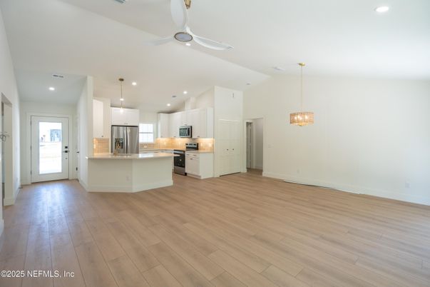 Empty room, Interior, Kitchen, Pendant Lights, Recessed Lighting, Stainless Steel Appliances, Wood Texture Flooring