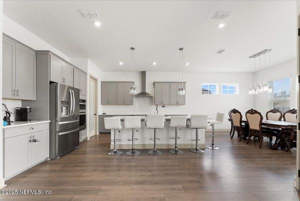 Dining room, Interior, Kitchen, Pendant Lights, Recessed Lighting, Stainless Steel Appliances, Wood Texture Flooring