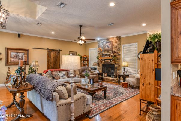 Fireplace, Interior, Living room, Recessed Lighting, Stone Walls, Wood Texture Flooring
