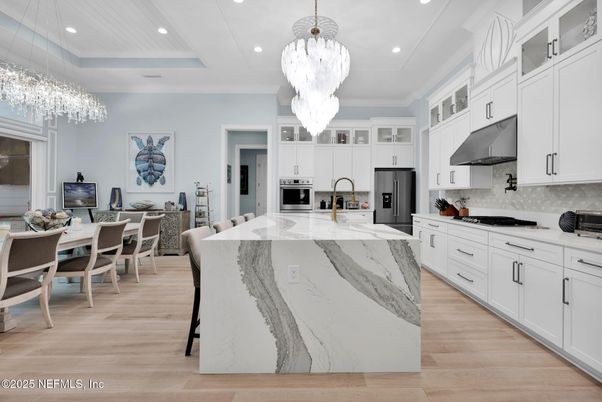 Chandelier, Dining room, Interior, Kitchen, Pendant Lights, Recessed Lighting, Stainless Steel Appliances, Wood Texture Flooring
