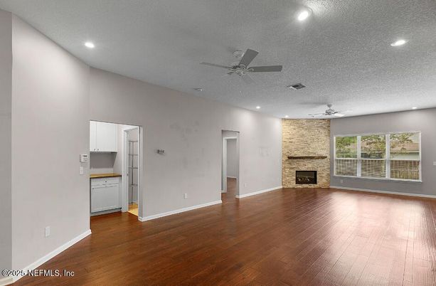 Empty room, Fireplace, Interior, Recessed Lighting, Stone Walls, Wood Texture Flooring
