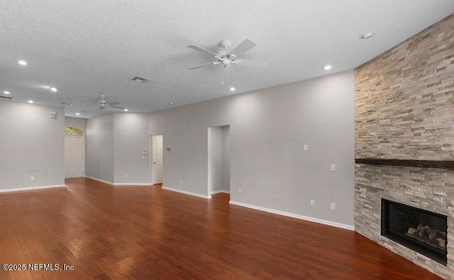 Empty room, Fireplace, Interior, Recessed Lighting, Stone Walls, Wood Texture Flooring