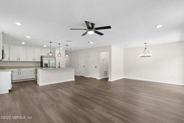 Empty room, Interior, Kitchen, Pendant Lights, Recessed Lighting, Stainless Steel Appliances, Wood Texture Flooring