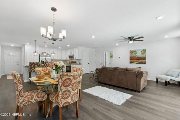 Chandelier, Dining room, Interior, Kitchen, Living room, Pendant Lights, Recessed Lighting, Stainless Steel Appliances, Wood Texture Flooring