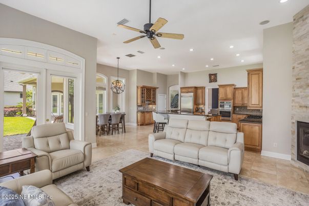 Chandelier, Dining room, Fireplace, Interior, Kitchen, Living room, Pendant Lights, Recessed Lighting, Stainless Steel Appliances, Stone Walls