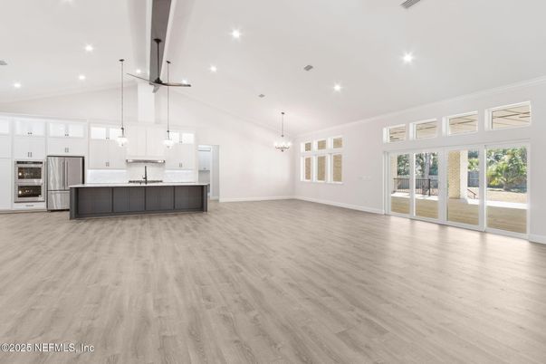 Chandelier, Empty room, Interior, Kitchen, Pendant Lights, Recessed Lighting, Stainless Steel Appliances, Wood Texture Flooring