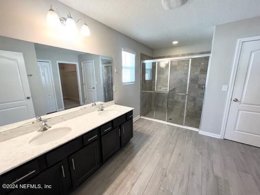 Bathroom, Dual Sink Vanities, Glass Shower, Interior, Recessed Lighting, Wood Texture Flooring