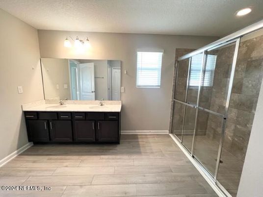 Bathroom, Dual Sink Vanities, Glass Shower, Interior, Recessed Lighting, Wood Texture Flooring