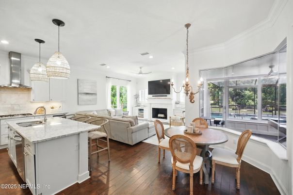 Chandelier, Dining room, Fireplace, Interior, Kitchen, Living room, Pendant Lights, Recessed Lighting, Stainless Steel Appliances, Wood Texture Flooring