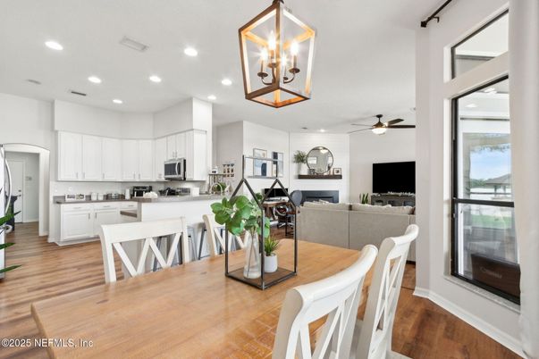 Dining room, Fireplace, Interior, Kitchen, Living room, Recessed Lighting, Stainless Steel Appliances, Wood Texture Flooring
