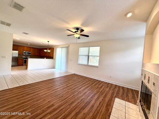 Empty room, Fireplace, Interior, Kitchen, Pendant Lights, Recessed Lighting, Wood Texture Flooring