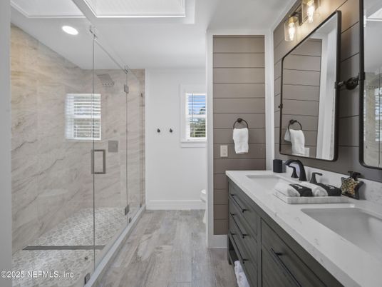Bathroom, Dual Sink Vanities, Glass Shower, Interior, Marble Walls, Recessed Lighting, Wood Texture Flooring