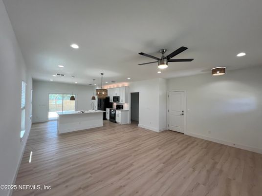 Empty room, Interior, Kitchen, Pendant Lights, Recessed Lighting, Stainless Steel Appliances, Wood Texture Flooring