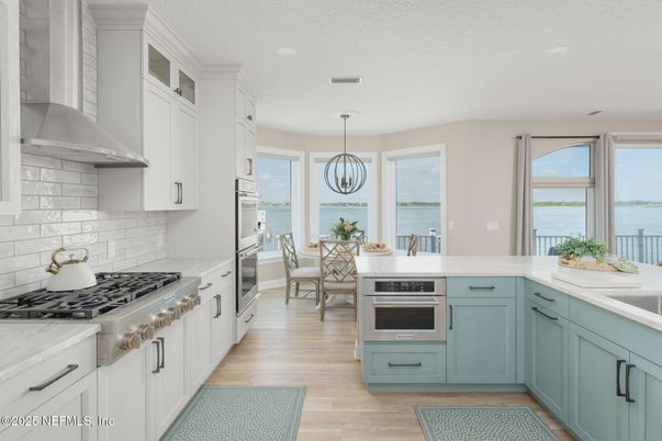 Chandelier, Dining room, Interior, Kitchen, Pendant Lights, Recessed Lighting, Stainless Steel Appliances, Water, Wood Texture Flooring