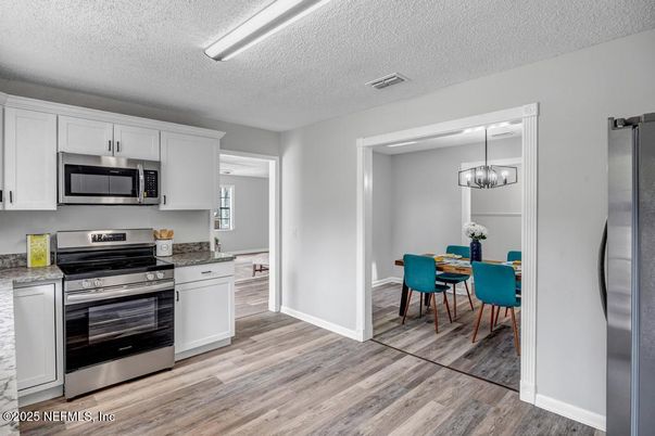 Chandelier, Dining room, Interior, Kitchen, Stainless Steel Appliances, Wood Texture Flooring