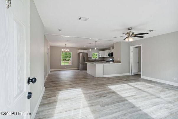 Chandelier, Empty room, Interior, Kitchen, Pendant Lights, Recessed Lighting, Stainless Steel Appliances, Wood Texture Flooring