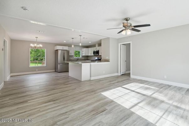 Chandelier, Empty room, Interior, Kitchen, Pendant Lights, Recessed Lighting, Stainless Steel Appliances, Wood Texture Flooring