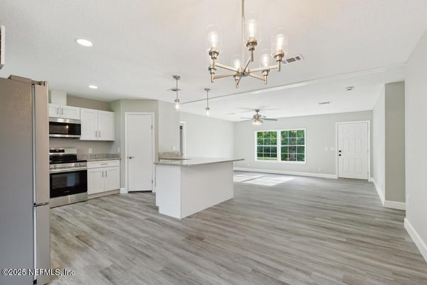 Chandelier, Empty room, Interior, Kitchen, Pendant Lights, Recessed Lighting, Stainless Steel Appliances, Wood Texture Flooring