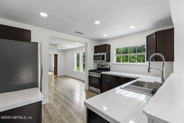 Interior, Kitchen, Recessed Lighting, Stainless Steel Appliances, Tile Countertops, Wood Texture Flooring