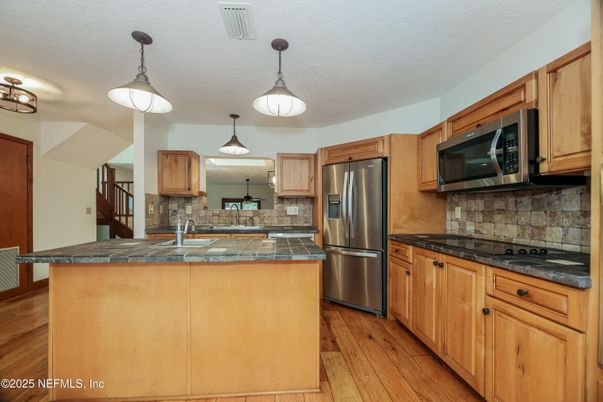 Interior, Kitchen, Pendant Lights, Tile Countertops, Wood Texture Flooring