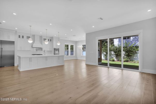 Empty room, Interior, Kitchen, Pendant Lights, Recessed Lighting, Stainless Steel Appliances, Wood Texture Flooring