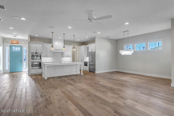 Chandelier, Empty room, Interior, Kitchen, Pendant Lights, Recessed Lighting, Stainless Steel Appliances, Wood Texture Flooring
