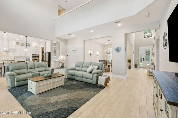 Chandelier, Dining room, Interior, Kitchen, Living room, Pendant Lights, Recessed Lighting, Stainless Steel Appliances, Wood Texture Flooring