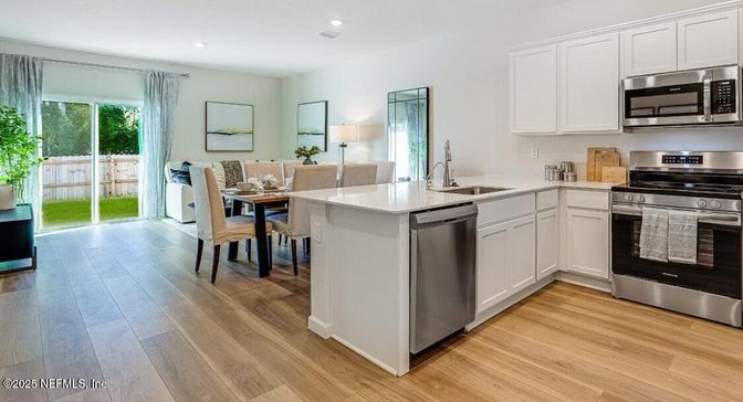 Dining room, Interior, Kitchen, Recessed Lighting, Stainless Steel Appliances, Wood Texture Flooring
