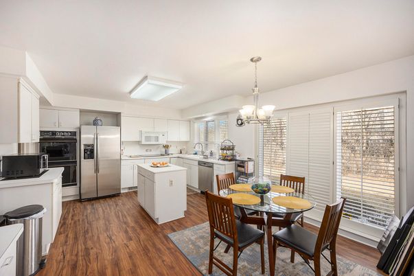 Chandelier, Dining room, Interior, Kitchen, Pendant Lights, Stainless Steel Appliances, Wood Texture Flooring