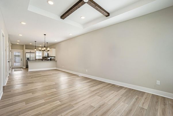 Empty room, Interior, Kitchen, Pendant Lights, Recessed Lighting, Stainless Steel Appliances, Wooden Beams, Wood Texture Flooring