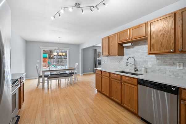 Chandelier, Dining room, Interior, Kitchen, Stainless Steel Appliances, Wood Texture Flooring