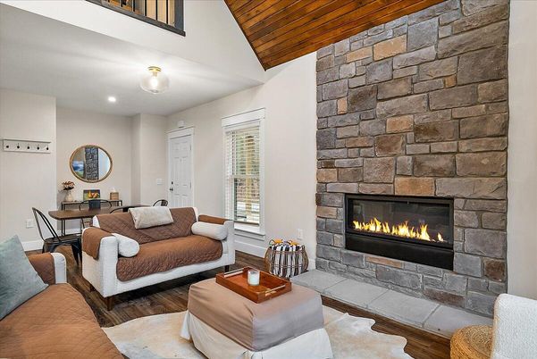 Dining room, Fireplace, Interior, Living room, Recessed Lighting, Stone Walls, Wooden Ceilings, Wood Texture Flooring
