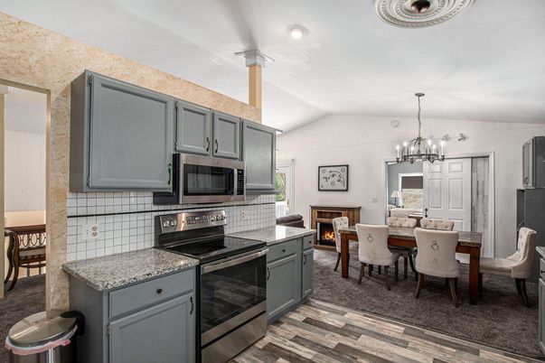Chandelier, Dining room, Fireplace, Interior, Kitchen, Recessed Lighting, Wood Texture Flooring