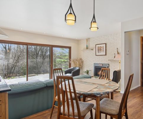 Dining room, Fireplace, Interior, Pendant Lights, Recessed Lighting, Stone Walls, Wood Texture Flooring