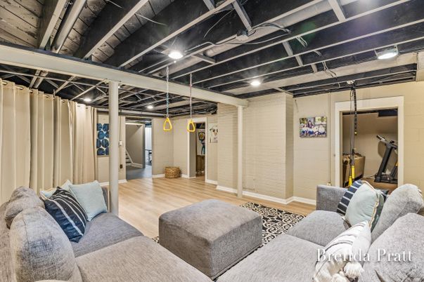 Fitness Equipment, Interior, Living room, Recessed Lighting, Stone Walls, Wood Texture Flooring