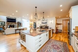 Fireplace, Interior, Kitchen, Living room, Pendant Lights, Recessed Lighting, Stainless Steel Appliances, Wood Texture Flooring