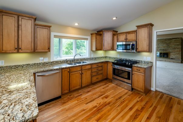 Fireplace, Interior, Kitchen, Recessed Lighting, Stainless Steel Appliances, Stone Walls, Wood Texture Flooring