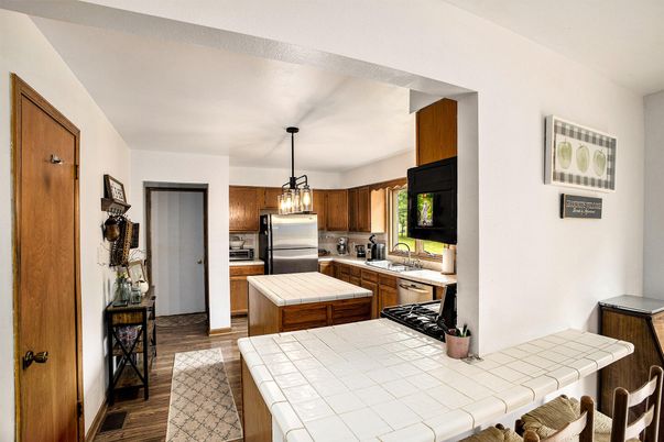 Interior, Kitchen, Pendant Lights, Stainless Steel Appliances, Tile Countertops, Wood Texture Flooring