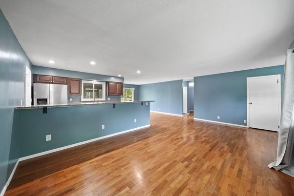 Empty room, Interior, Kitchen, Recessed Lighting, Stainless Steel Appliances, Wood Texture Flooring