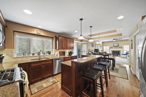 Dining room, Fireplace, Interior, Kitchen, Pendant Lights, Recessed Lighting, Stainless Steel Appliances, Wood Texture Flooring