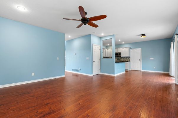 Empty room, Interior, Kitchen, Recessed Lighting, Stainless Steel Appliances, Wood Texture Flooring