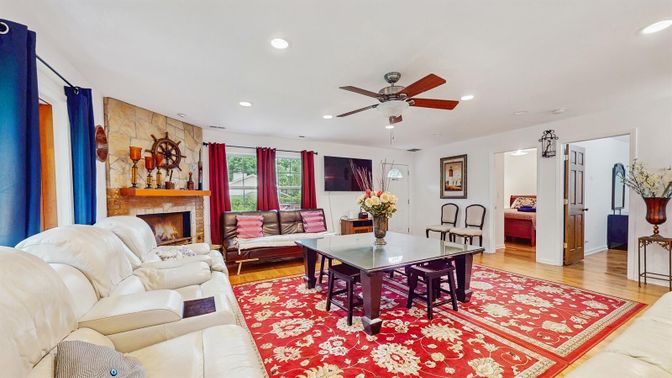 Dining room, Fireplace, Interior, Living room, Recessed Lighting, Stone Walls, Wood Texture Flooring