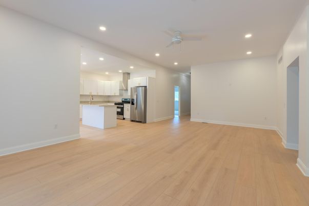 Empty room, Interior, Kitchen, Recessed Lighting, Stainless Steel Appliances, Wood Texture Flooring