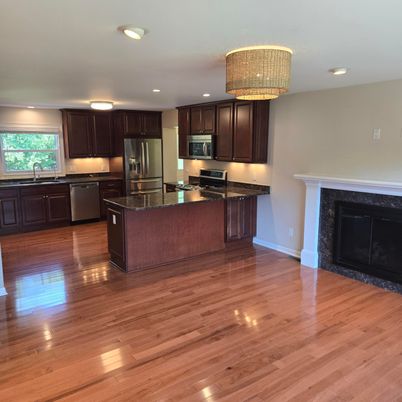 Chandelier, Fireplace, Interior, Kitchen, Recessed Lighting, Stainless Steel Appliances, Wood Texture Flooring