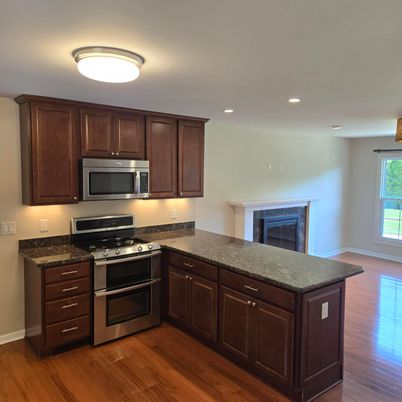 Fireplace, Interior, Kitchen, Recessed Lighting, Stainless Steel Appliances, Wood Texture Flooring